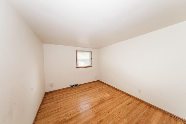 spare room featuring light hardwood / wood-style floors