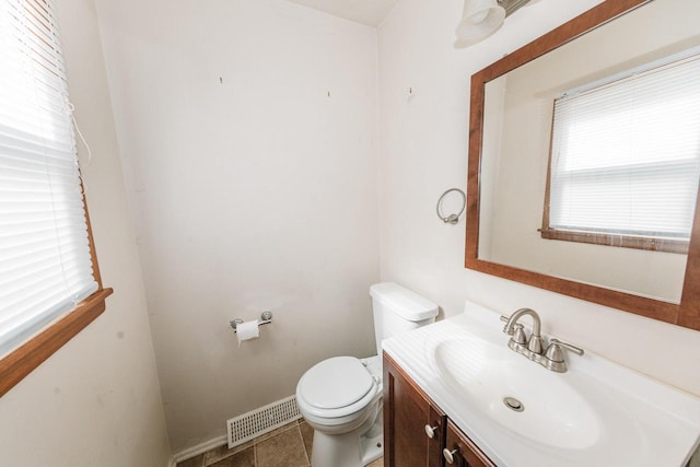 bathroom with vanity, tile patterned floors, and toilet