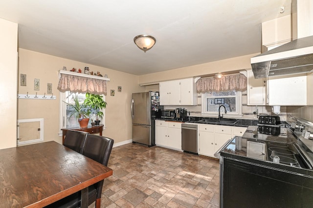 kitchen featuring white cabinetry, appliances with stainless steel finishes, sink, and a healthy amount of sunlight