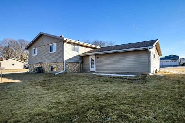 back of house featuring a yard and central AC unit