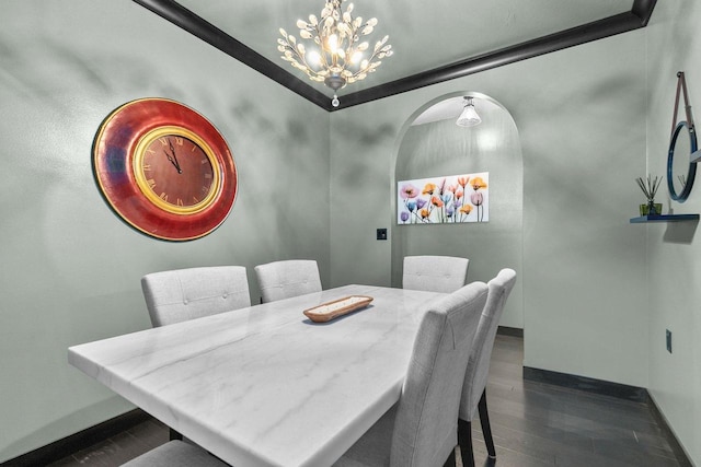 dining room with dark wood-type flooring and an inviting chandelier