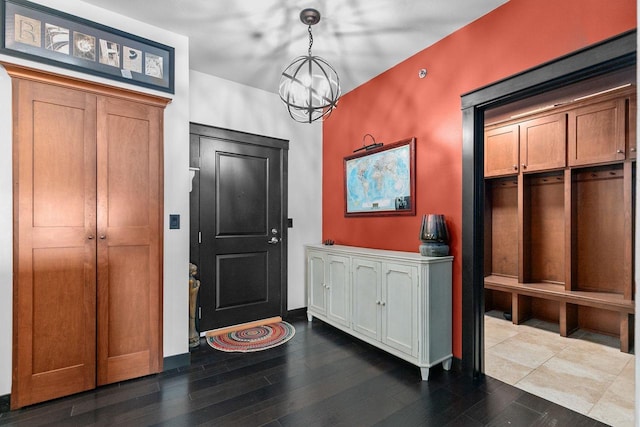 entryway featuring dark hardwood / wood-style floors and a notable chandelier