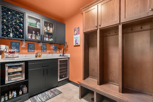 mudroom featuring beverage cooler and indoor bar