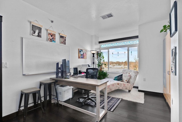 office with dark hardwood / wood-style flooring and a textured ceiling