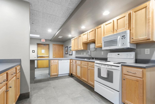 kitchen with white appliances, a paneled ceiling, sink, and light brown cabinets