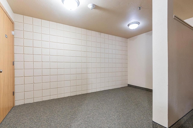 empty room featuring dark colored carpet