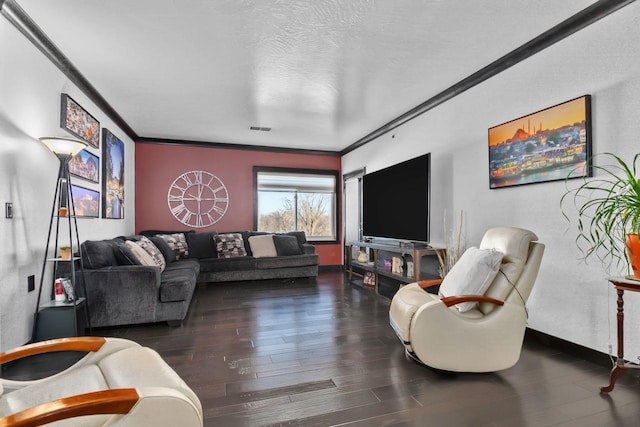 living room featuring ornamental molding, dark hardwood / wood-style floors, and a textured ceiling