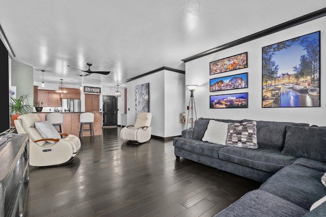 living room with ornamental molding, a textured ceiling, and dark hardwood / wood-style flooring