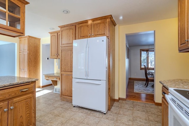 401 E Riverside Ave, Merrill, WI 54452 - kitchen featuring light stone counters and white appliances
