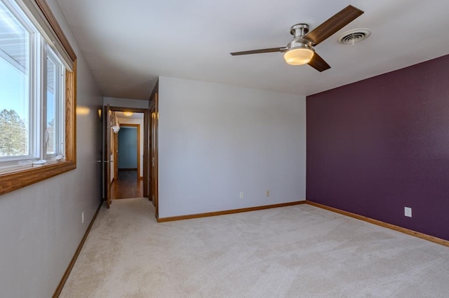401 E Riverside Ave, Merrill, WI 54452 - carpeted empty room with ceiling fan