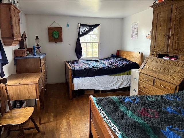 bedroom with dark hardwood / wood-style floors