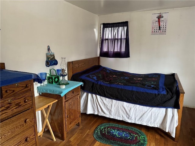 bedroom with dark wood-type flooring