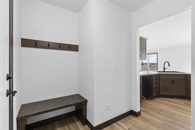 mudroom featuring sink and light hardwood / wood-style flooring