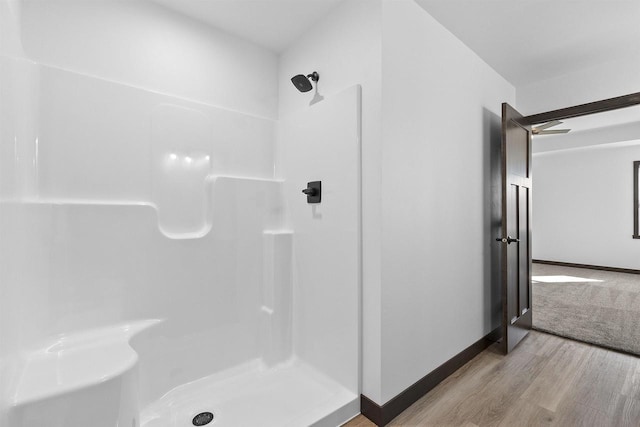 bathroom with wood-type flooring and walk in shower