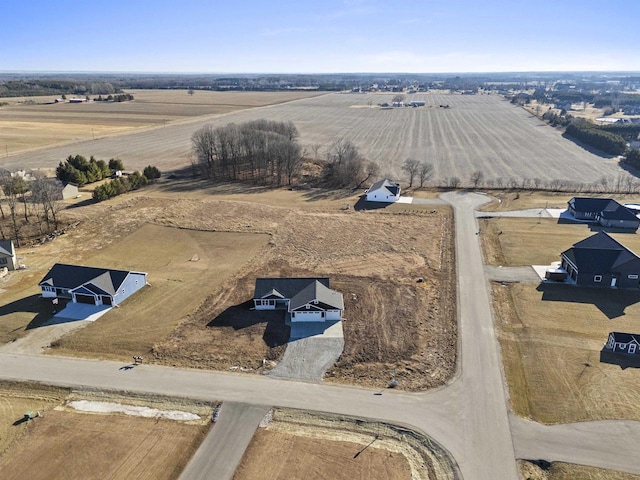 birds eye view of property with a rural view