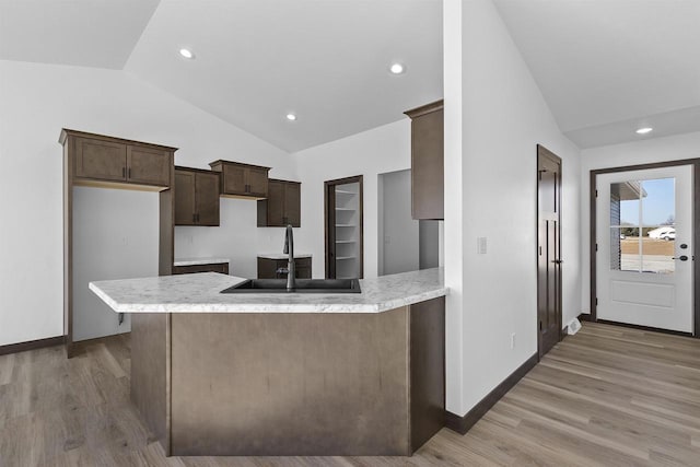 kitchen featuring sink, light hardwood / wood-style floors, and kitchen peninsula