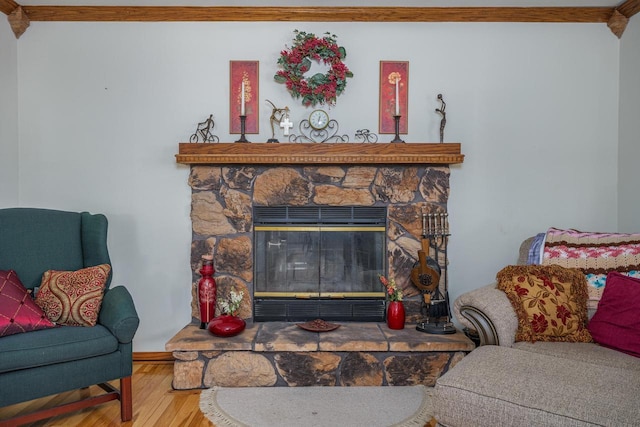 living room with hardwood / wood-style floors, crown molding, and a fireplace