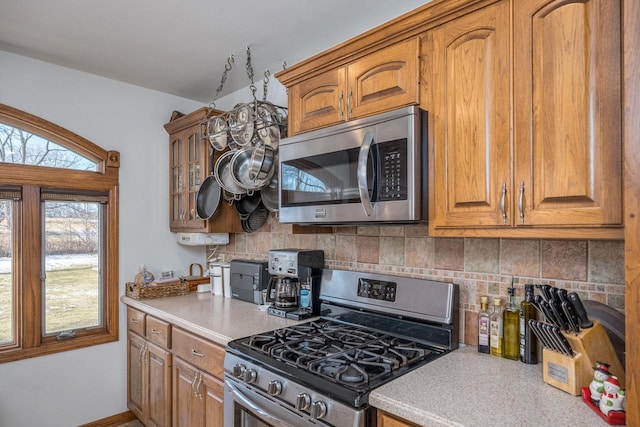 kitchen featuring appliances with stainless steel finishes and decorative backsplash