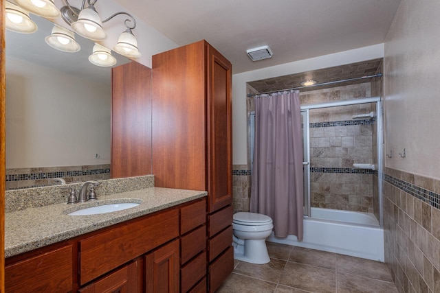 full bathroom featuring tiled shower / bath combo, vanity, tile walls, and tile patterned floors