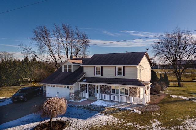 view of front of house with a porch, a garage, and central AC unit