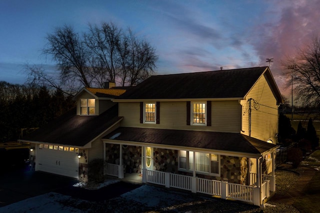 view of front of house featuring a garage and a porch