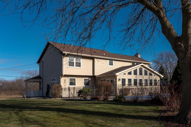 back of house featuring a yard