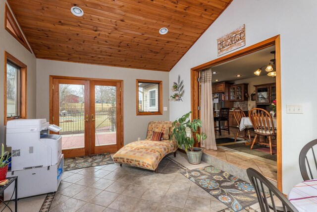 sitting room featuring lofted ceiling, light tile patterned floors, wooden ceiling, and french doors