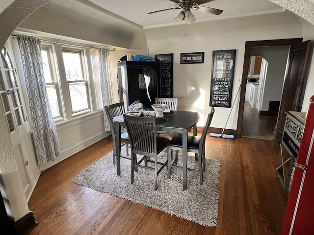 dining space featuring crown molding, dark hardwood / wood-style floors, and ceiling fan