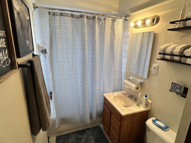 full bathroom with vanity, shower / tub combo, and toilet