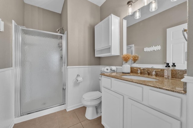 bathroom with an enclosed shower, vanity, tile patterned floors, and toilet