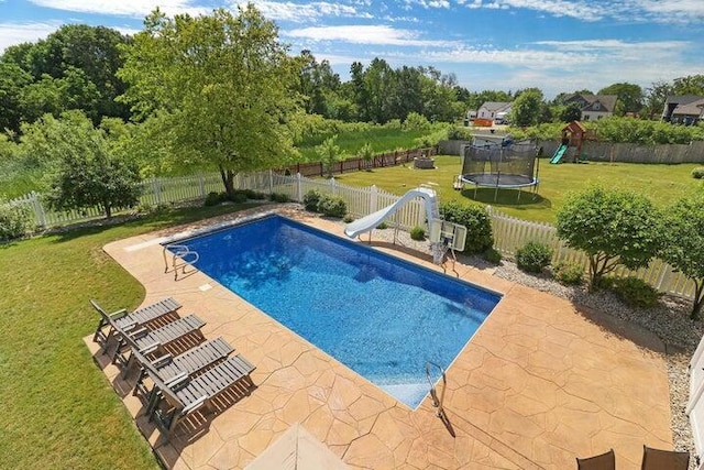 view of pool featuring a playground, a patio, a lawn, a trampoline, and a water slide