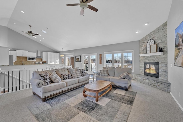 living room featuring light carpet, a fireplace, high vaulted ceiling, and ceiling fan