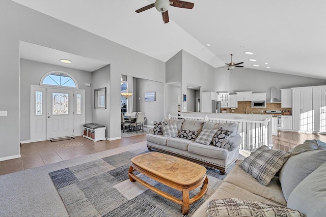 tiled living room featuring high vaulted ceiling and ceiling fan