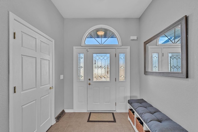 tiled foyer featuring a healthy amount of sunlight