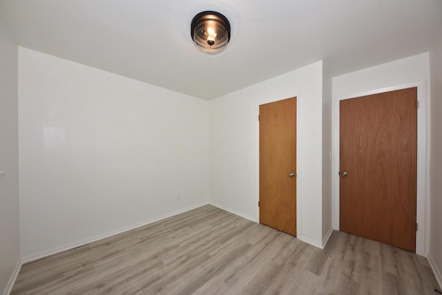 spare room featuring light hardwood / wood-style flooring