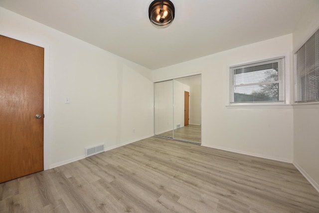 spare room with light hardwood / wood-style floors