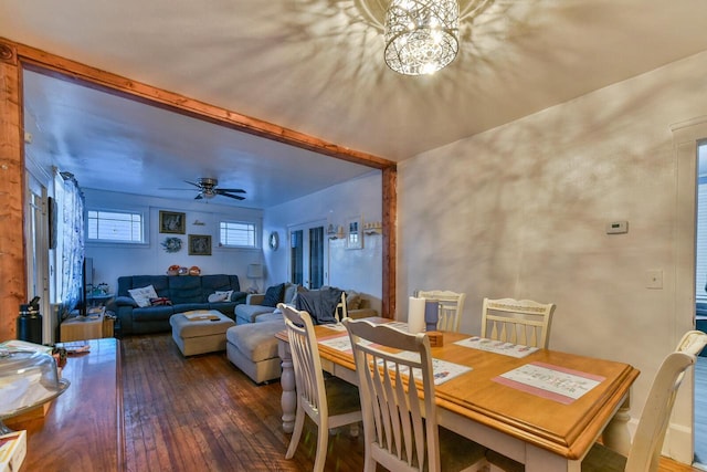 dining room with hardwood / wood-style floors and ceiling fan with notable chandelier