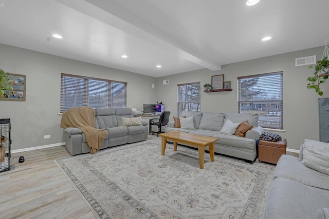 living room with beam ceiling and light hardwood / wood-style flooring