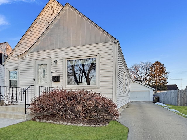 view of front of house with an outbuilding, a garage, and a front yard