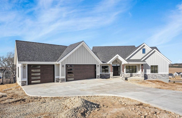 625 Interlachen Ave, Oregon, WI 53575 - view of front of home with stone siding, board and batten siding, and an attached garage
