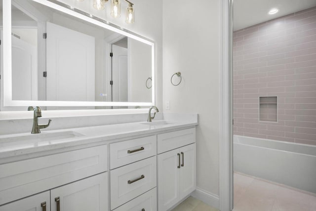 bathroom featuring vanity, tile patterned floors, and tiled shower / bath