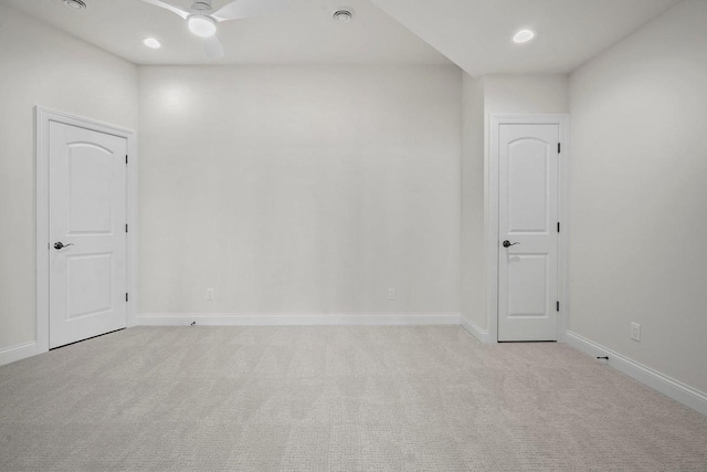 empty room featuring light carpet and ceiling fan