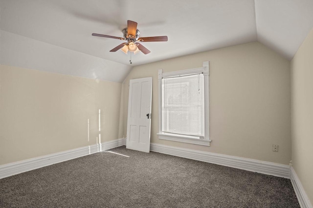 bonus room with dark colored carpet, vaulted ceiling, and ceiling fan