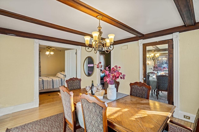 dining space featuring beam ceiling, light hardwood / wood-style flooring, and ceiling fan with notable chandelier