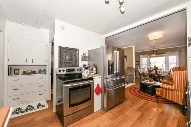 kitchen featuring light hardwood / wood-style flooring, white cabinets, and appliances with stainless steel finishes