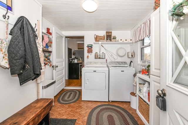 clothes washing area featuring independent washer and dryer