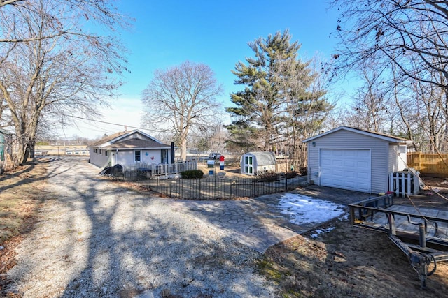 view of yard with a garage and a storage shed