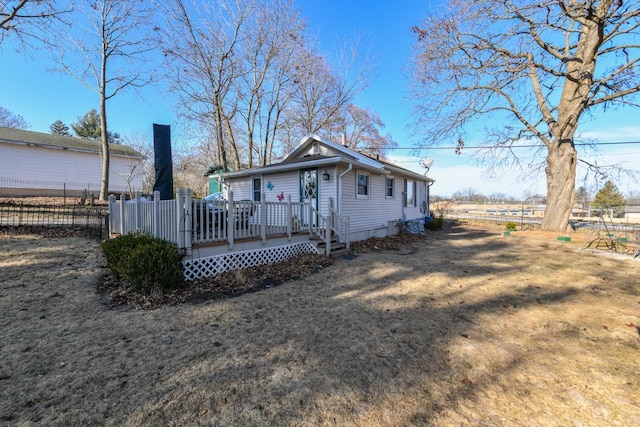 view of front facade featuring a deck and a front lawn