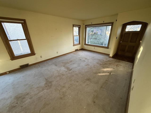 view of carpeted foyer entrance