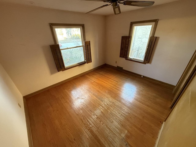 empty room featuring wood-type flooring and ceiling fan